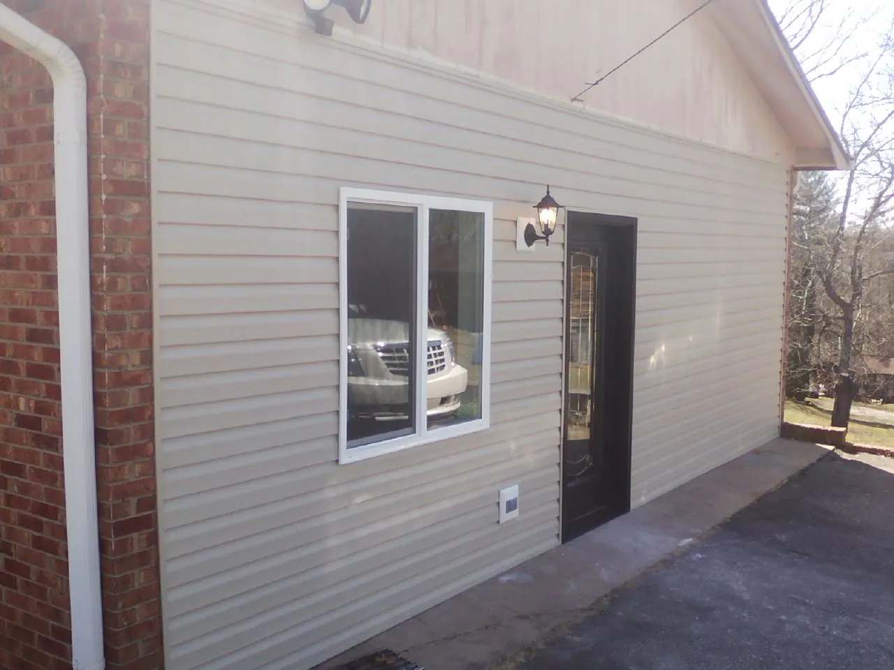 New vinyl siding and entry door on a room addition in Miami Beach